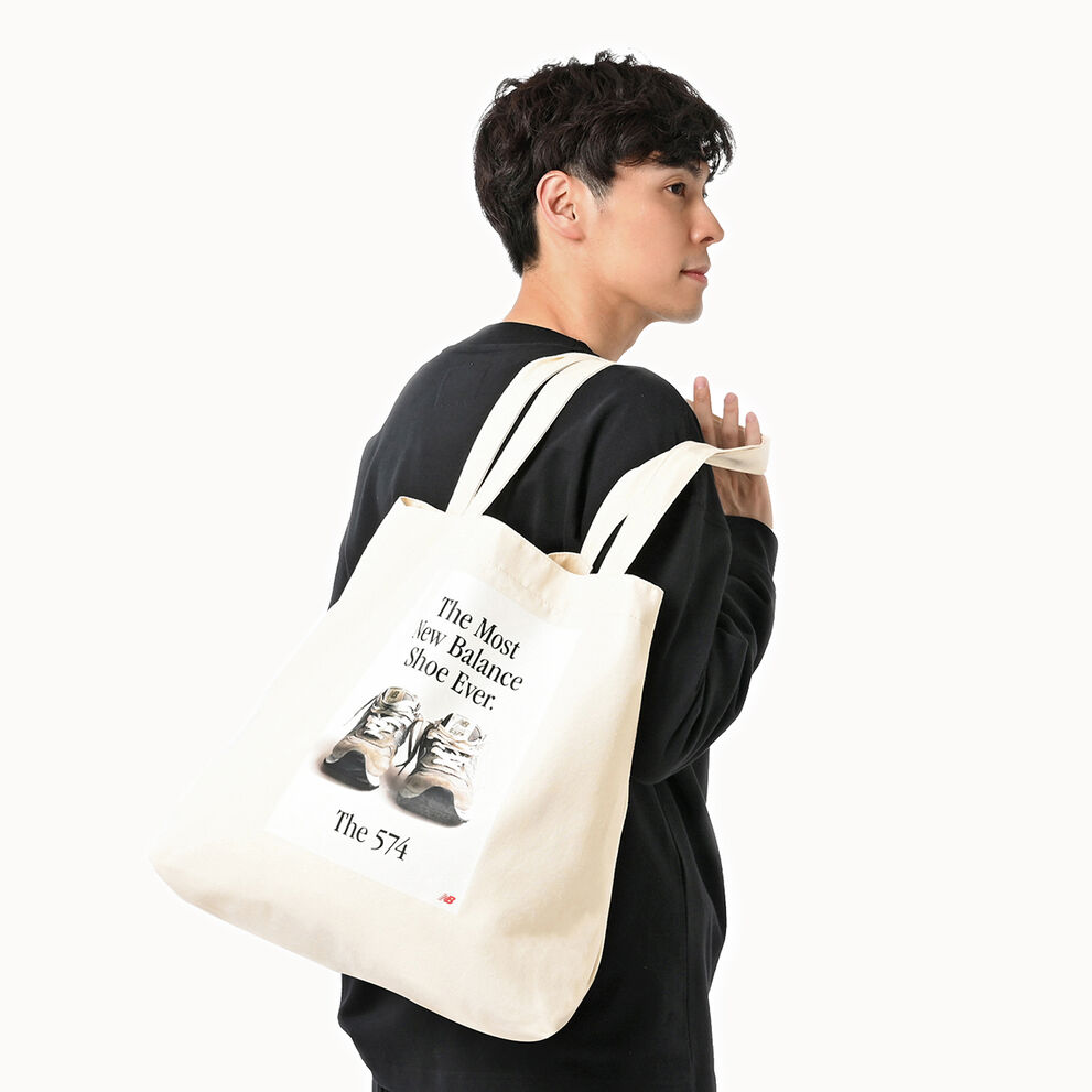 Man holding New Balance tote bag. 